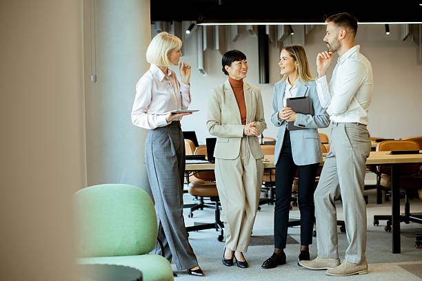 istock Group of four professionals having a discussion in a modern office setting 2255086463