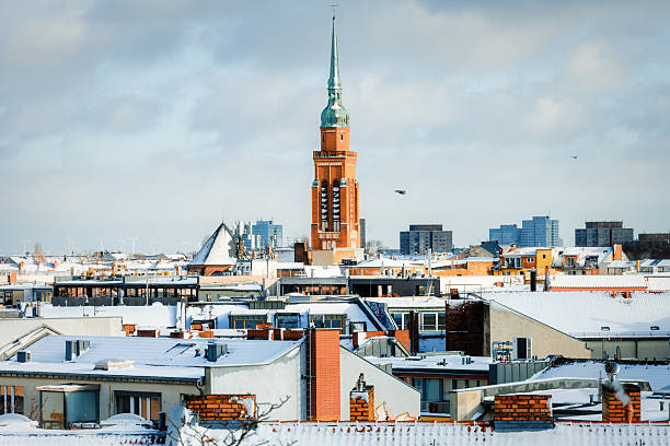 rooftop view on snowy  berlin prenzlauer berg with church tower of the Segenskirche