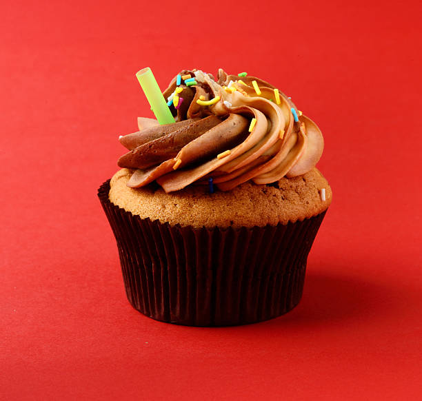 One Year Old Boy Birthday Cupcakes with candy and present decorations on a blue background