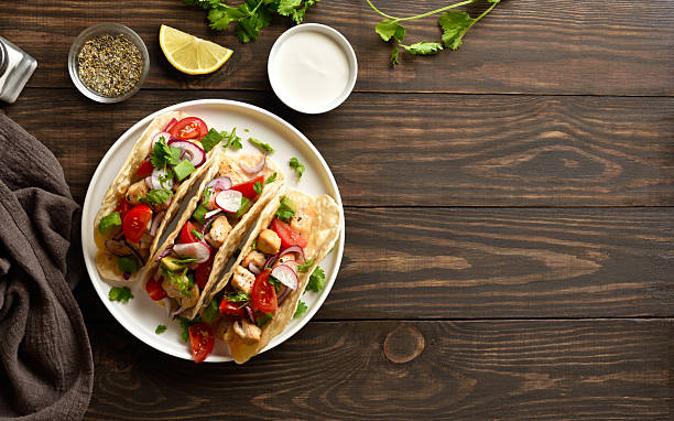 istock Tacos with vegetables and meat on wooden background 2255091396
