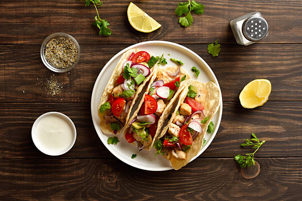 istock Tacos with vegetables and meat on wooden background 2255091402