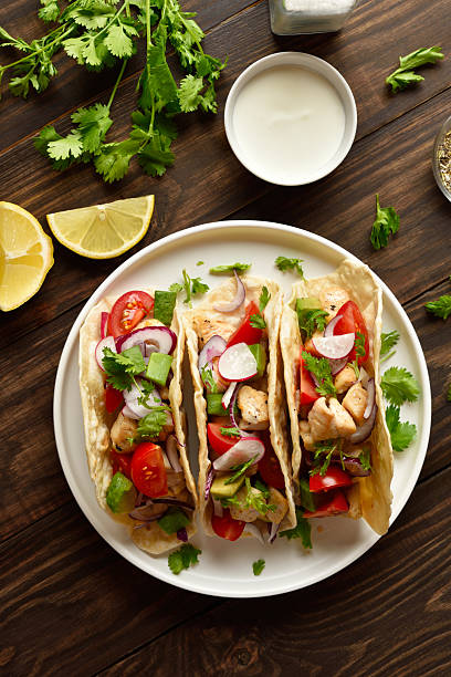 istock Tacos with vegetables and meat on wooden background 2255091404