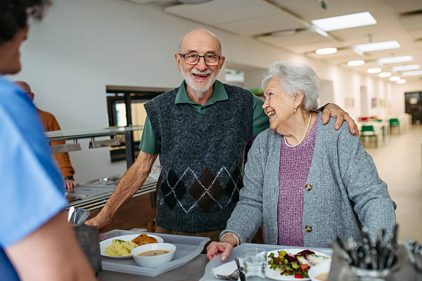 istock Elderly couple having lunch in community center cafeteria. 2255096112