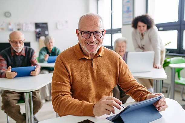 istock Senior man learning digital skills in community center. 2255096236