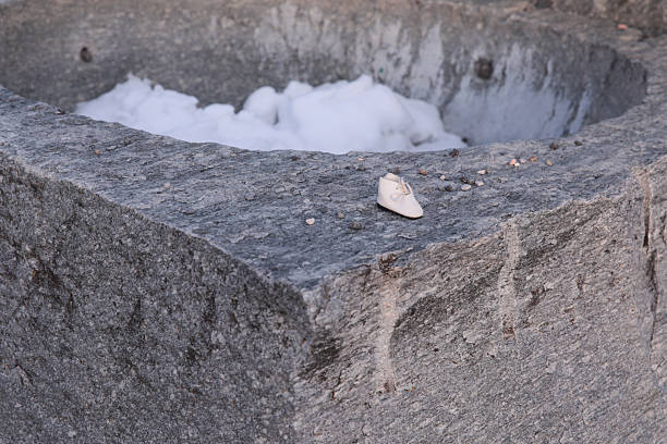 Single lost shoe on snow-covered stone