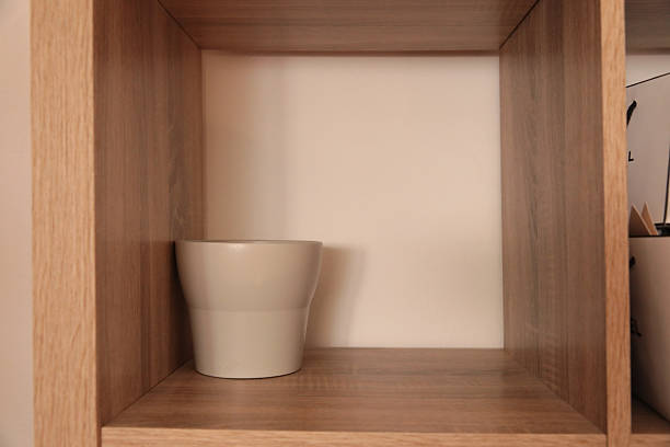 Minimalist wooden shelf with white ceramic vase