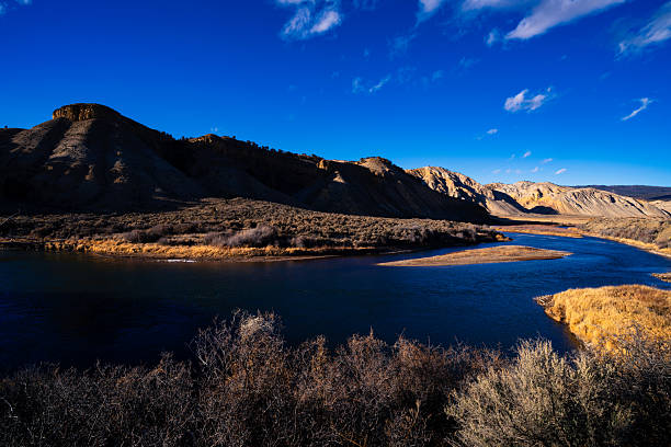 Scenic landscape with tthe Colorado River in warm afternoon light flowing through scenic canyon and mountains in western Colorado USA.