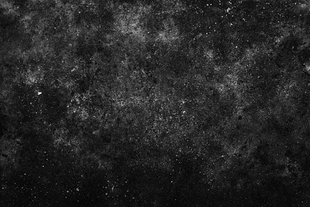 istock Dark abstract background, weathered stone surface, speckled white particles, cinematic grunge texture, monochromatic obsidian wall, industrial aesthetic, worn material, cosmic atmosphere 2255103640