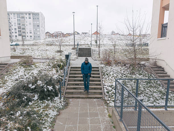 Man walks on  empty city streets on very cold winter day