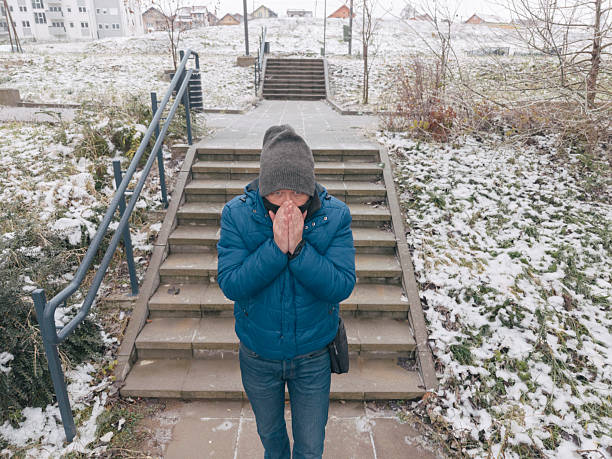 Man walks on  empty city streets on very cold winter day