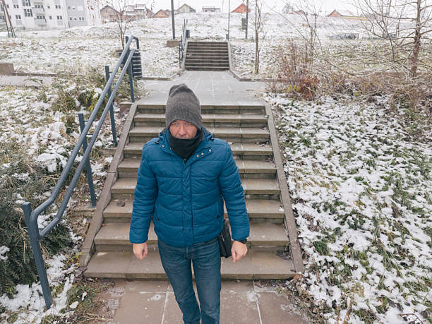 Man walks on  empty city streets on very cold winter day