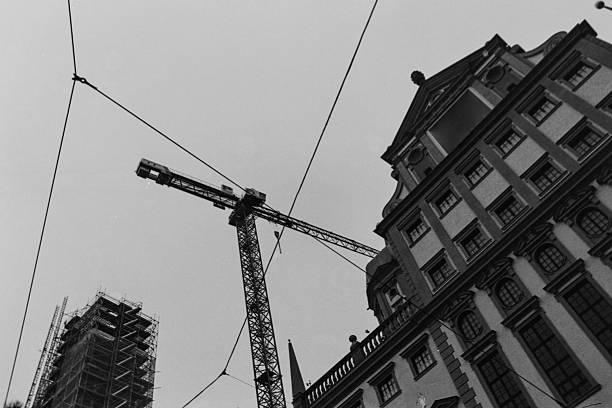 istock Augsburg Town Hall under extensive repairs, missing its two towers on each side. Urban construction scene with tower crane and wires in the historical city centre 2255106389