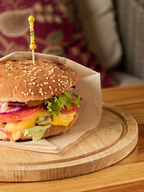 Inviting atmosphere showcasing hearty cheeseburger with fresh vegetables and crispy bacon
