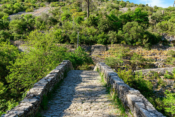 Old stone bridge over terraced hillside Navacelles