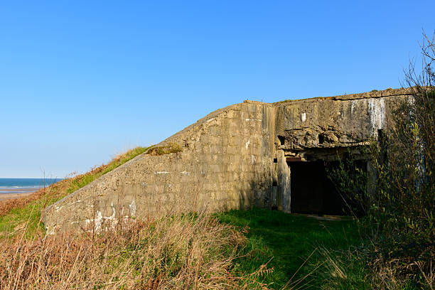 istock Concrete bunker on grassy Omaha Beach hillside 2255113090