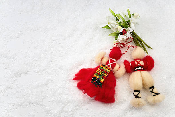 Bulgarian martenitsa dolls and snowdrops on snow celebrating baba marta holiday