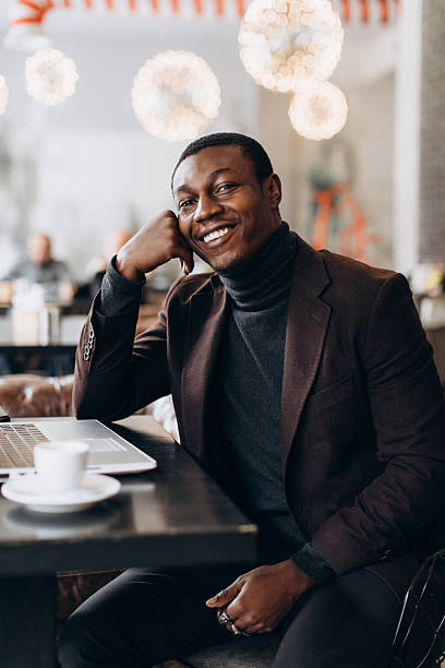 istock Happy young black man working remotely in a cafe 2255117561