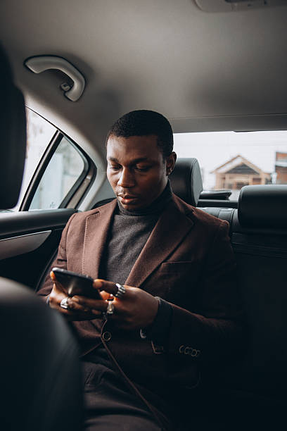 istock Black businessman checking phone while commuting in car 2255117859