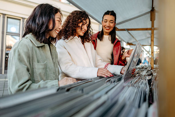 A person browses and flips through vinyl records on the shelves of a record store, immersed in the hunt for music and enjoying the tactile experience of crate digging.