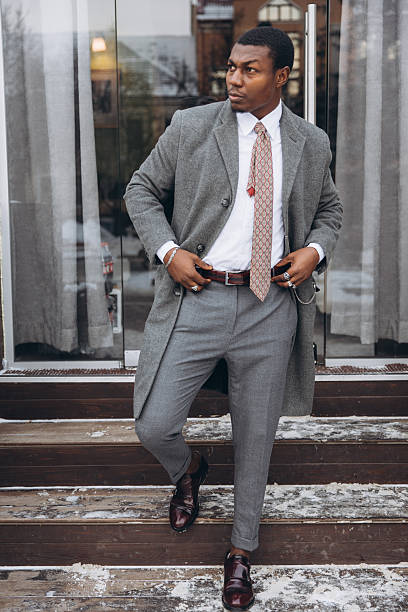 istock Stylish african american man standing on snowy steps 2255119399