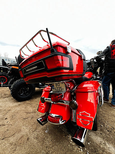 Ternopil,Ukraine - November 29, 2025: Red Harley-Davidson Electra Glide Ultra Limited touring motorcycle with chrome details and luggage on a dirt lot display during a show.