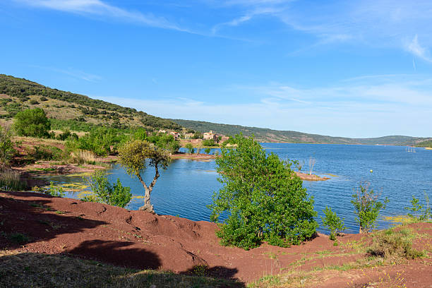 istock Red earth shoreline and blue water at Lac de Salagou 2255122845