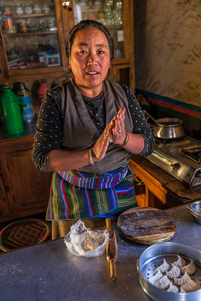 Tibetan woman preparing momos, Upper Mustang, Nepal