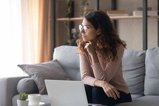 istock Distracted from online computer work young woman looking in distance. 2255127204