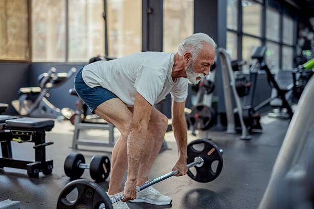 istock Older Man Performing Strength Workout At Gym 2255127530