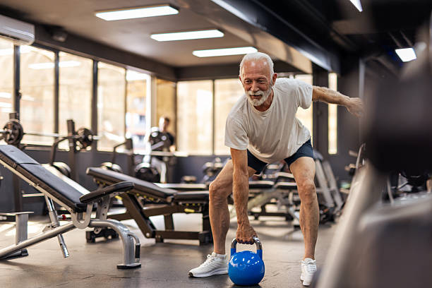 istock Elderly Athlete Practicing Kettlebell Exercise In Fitness Center 2255127547
