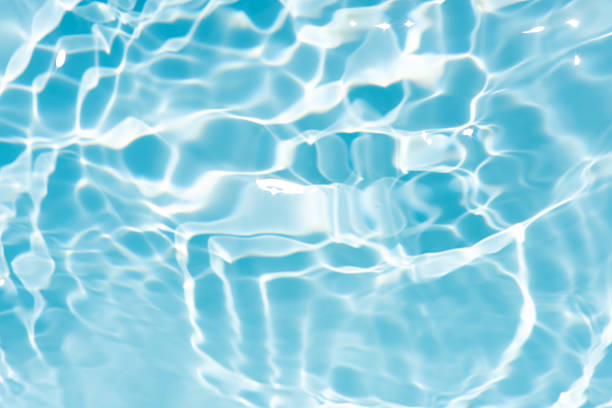 istock Bluewater waves on the surface ripples blurred. Defocus blurred transparent blue colored clear calm water surface texture with splash and bubbles. Water waves with shining pattern texture background. 2255129768