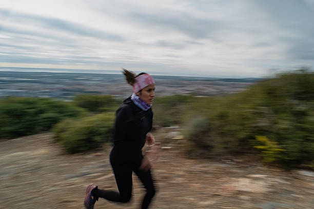 Glasgow, UK, March 17th 2024, Woman running in the city for health and wellbeing