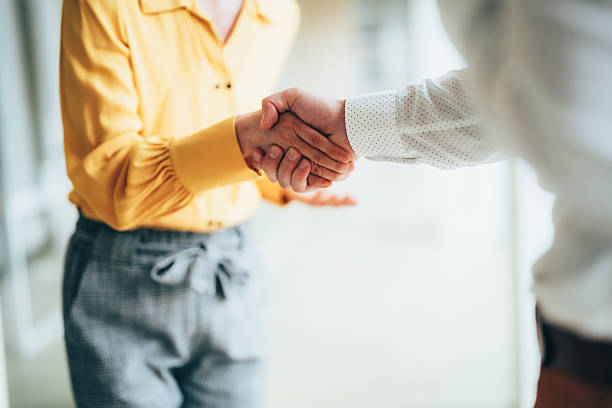istock Business partners concluding deal with handshake 2255135337