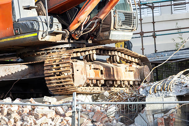 Closeup Excavator at demolition site, side view, background with copy space, full frame horizontal composition