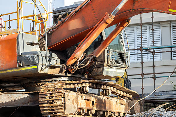 Closeup Excavator at demolition site, background with copy space, full frame horizontal composition