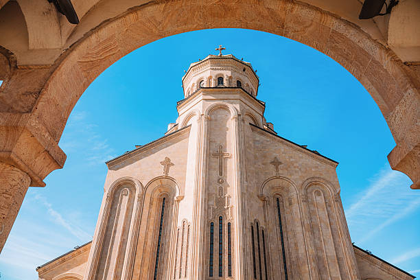 Holy Trinity Cathedral, also known as Sameba, framed by a stone arch in Tbilisi, Georgia