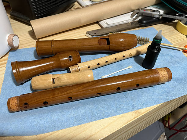 soprano and tenor baroque recorders being oiled as part of regular care, highlighting traditional craftsmanship and preservation of wooden musical instruments