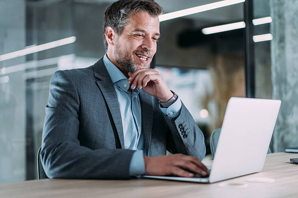 istock Successful businessman in modern office working on laptop. 2255145891