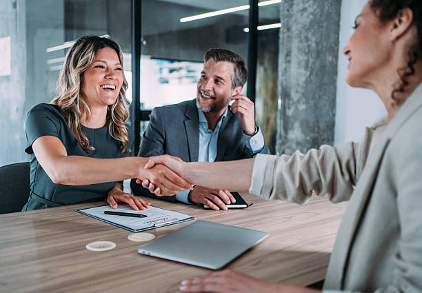 istock Businesspeople shaking hands across the table. 2255145903