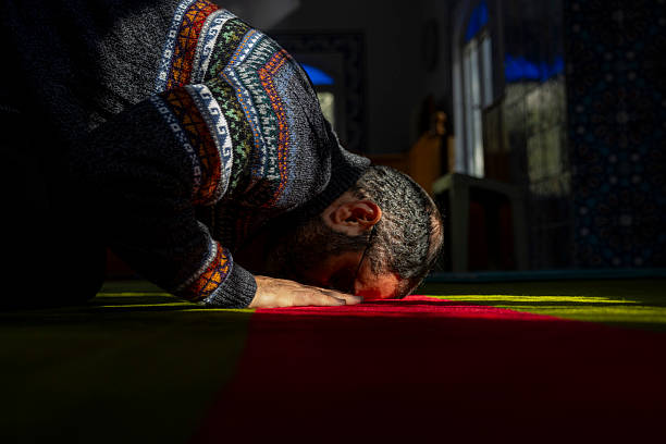 Person man, turned to God in prayer, demonstrating their religious faith and devotion through worship. Man hand in prayer, expressing his religious faith in God through worship of Jesus Christ.