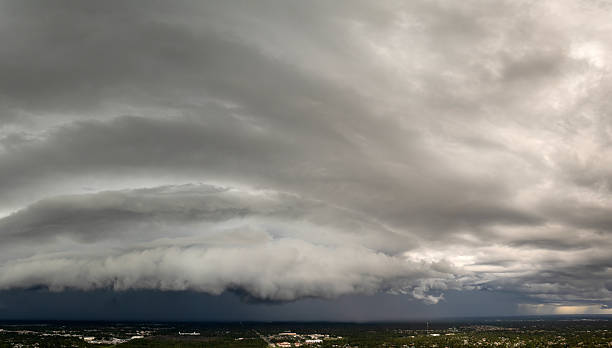 istock Heavy rain falling down from stormy clouds over rural Florida suburbs. Thunderstorm on dark sky. Moving and changing cloudscape weather 2255162190