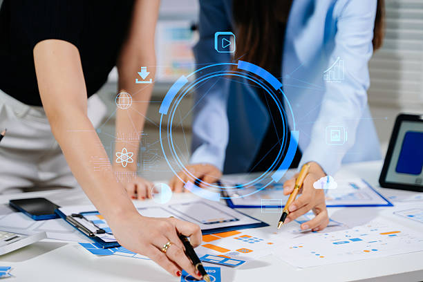 istock Close up view of UI developer team brainstorming on their project with laptop, smartphone and digital tablet. Creative digital development agency. 2255162361