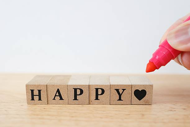 Happy and heart symbols made from wooden blocks.
