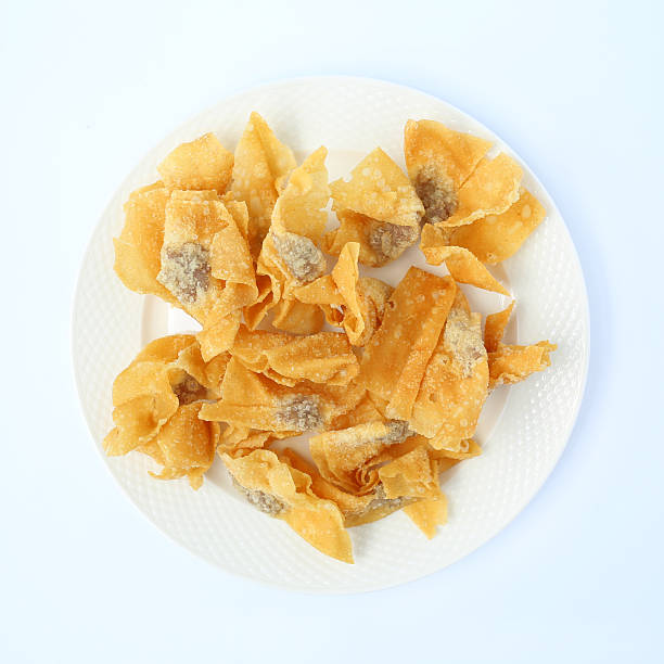 istock Crispy golden fried wontons served on a white plate, a perfect crunchy appetizer. 2255175466