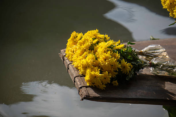The stems are carefully wrapped in small plastic bags filled with water to keep the flowers fresh.