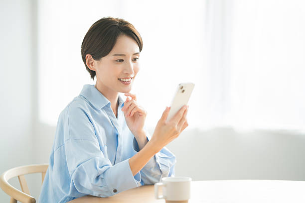 istock A Japanese woman in her 30s using a smartphone at home 2255180367