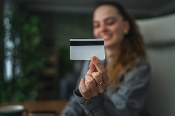 istock Woman presenting blank credit card for online payment 2255182350