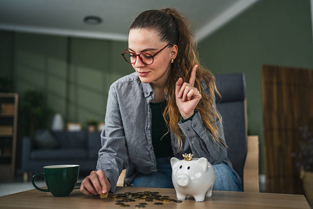 istock Woman counting savings coins having a financial idea 2255183021
