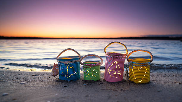 istock Colorful DIY Can Lights with Maritime Motifs Illuminating a Summer Beach 2255184976