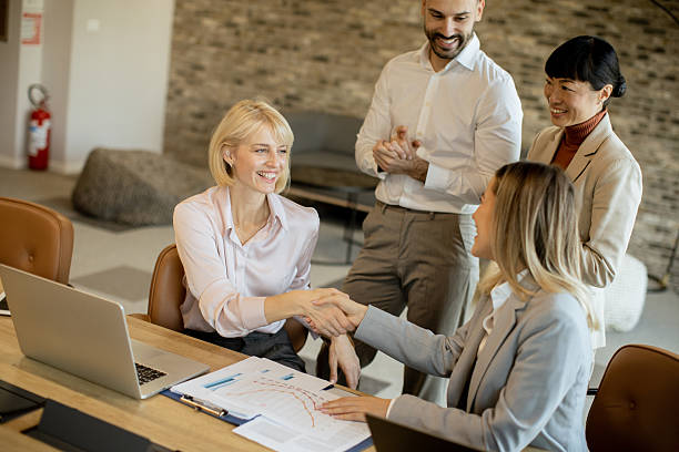 istock Team celebrates successful business meeting with handshake and smiles 2255190450